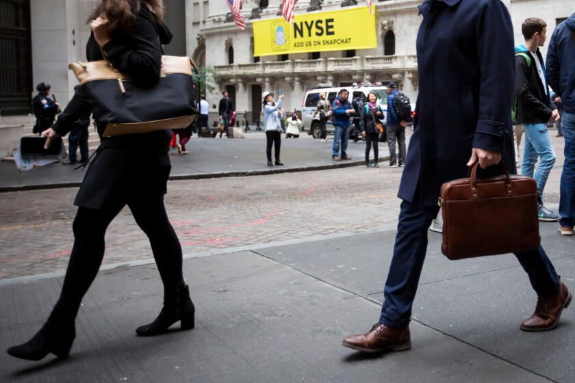 People walking in front of Stock Exchange New York Bloomberg News.jpg