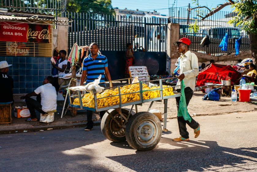 A street trader wheels a cart laden with bananas along a street in Maputo, Mozambique, on Thursday, March 23, 2017. Mozambique missed a $119 million payment due Tuesday on a loan Credit Suisse Group AG arranged, the second debt repayment the government failed to make in as many months. Photographer: Waldo Swiegers/Bloomberg