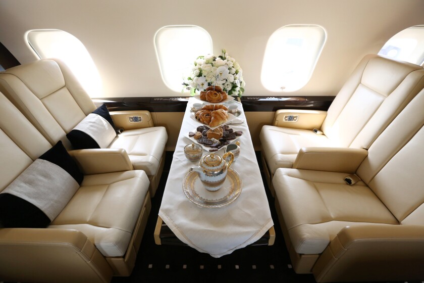 A table set for dining sits aboard a Bombardier Inc. Global 6000 business jet at the Singapore Airshow held at the Changi Exhibition Centre in Singapore.
