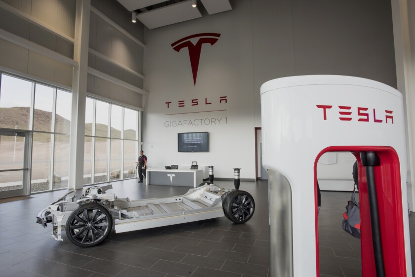 A vehicle charger, right, stands in the lobby at the Tesla Motors Inc. Gigafactory in McCarran, Nevada.