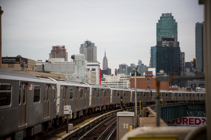 A 7 subway train runs along elevated tracks in the Queens borough of New York.