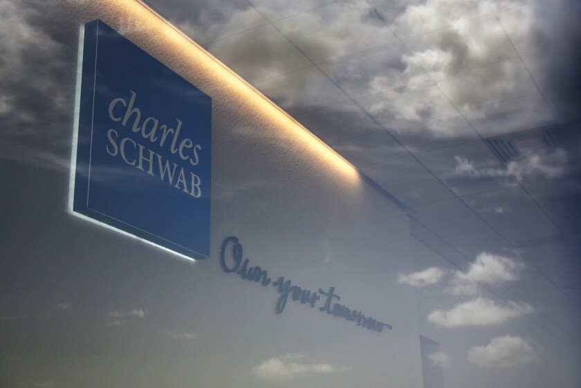 Clouds are reflected in the window of a Charles Schwab Corp. location in San Antonio, Texas, U.S., on Sunday, July 15, 2018. Charles Schwab Corp. is scheduled to release earnings figures on July 17. Photographer: Callaghan O'Hare/Bloomberg News