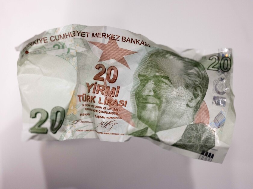 A crumpled 20 Turkish Lira banknotes sits in this arranged photograph in London, U.K., on Wednesday, Aug. 15, 2018. Turkey took its boldest steps yet to try to ward off a financial crisis by making it harder for traders to bet against the battered lira and easing rules on restructuring troubled loans that have already topped $20 billion.