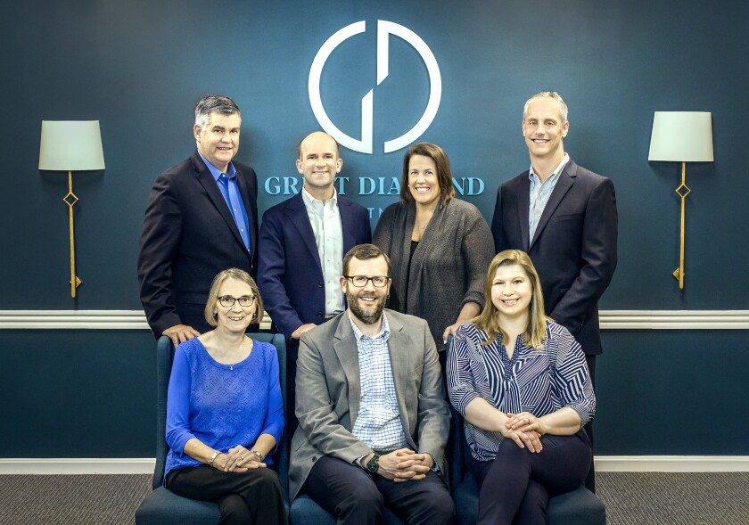 Great Diamond Partners left UBS to open an independent firm in Portland, Maine. From left to right, standing: Joseph Powers, Jack Piper, Helen Andreoli, Steven Tenney. Sitting left to right: Susan Welsch, Andrew Scott, Meg Scott.
