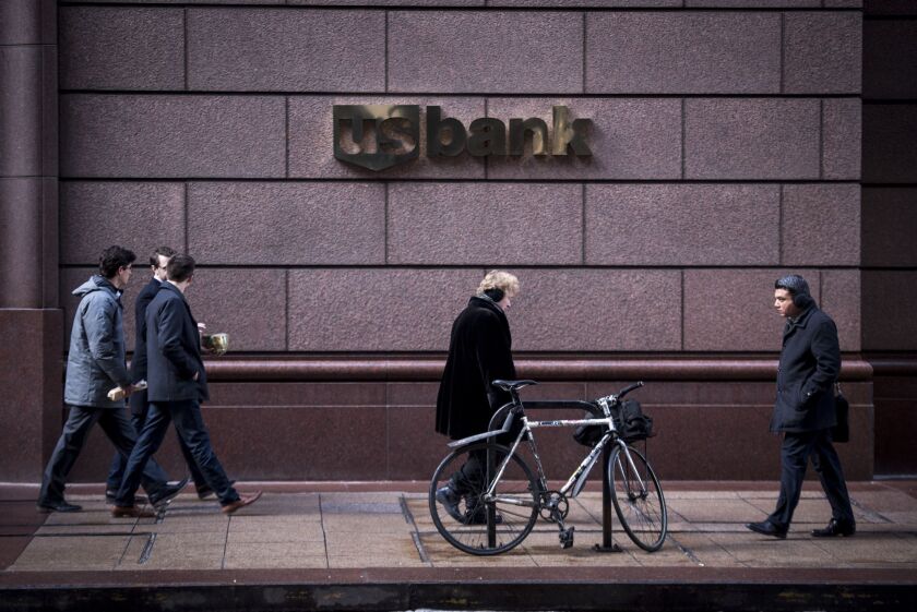 Pedestrians pass in front of a US Bancorp branch in downtown Chicago, Illinois, U.S., on Tuesday, Jan. 9, 2018. US Bancorp is scheduled to release earnings figures on January 17. Photographer: Christopher Dilts/Bloomberg.