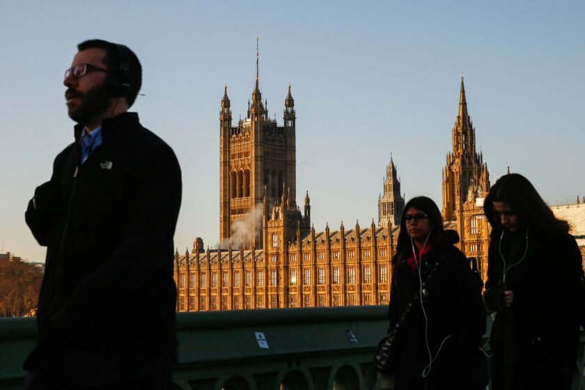 Pedestrians cross Westminster Bridge in view of the Houses of Parliament in London, U.K., on Tuesday, Dec. 11, 2018. Faced with a Brexit vote she can't win, U.K. Prime Minister Theresa May appears to be gambling that running down the clock to a no-deal departure might change the arithmetic in Parliament. Photographer: Luke MacGregor/Bloomberg