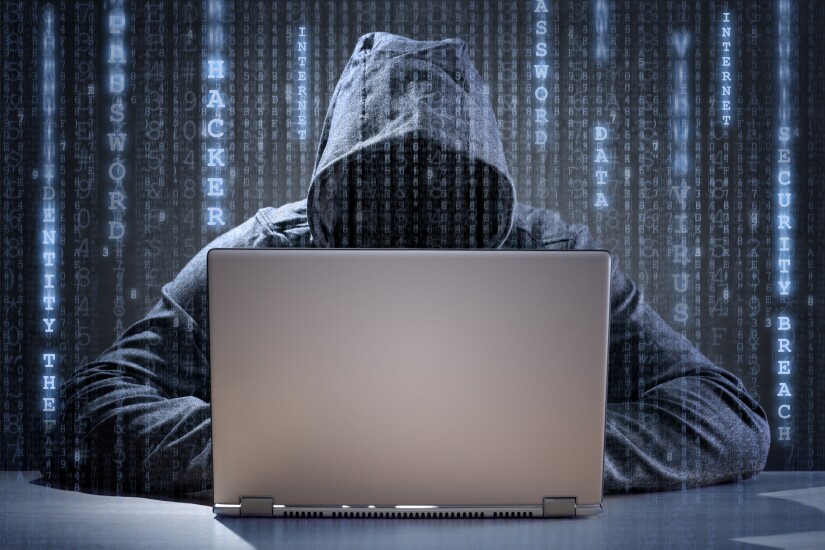 Hooded computer hacker.