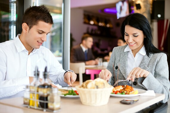 A woman and a man on a business lunch in a restaurant