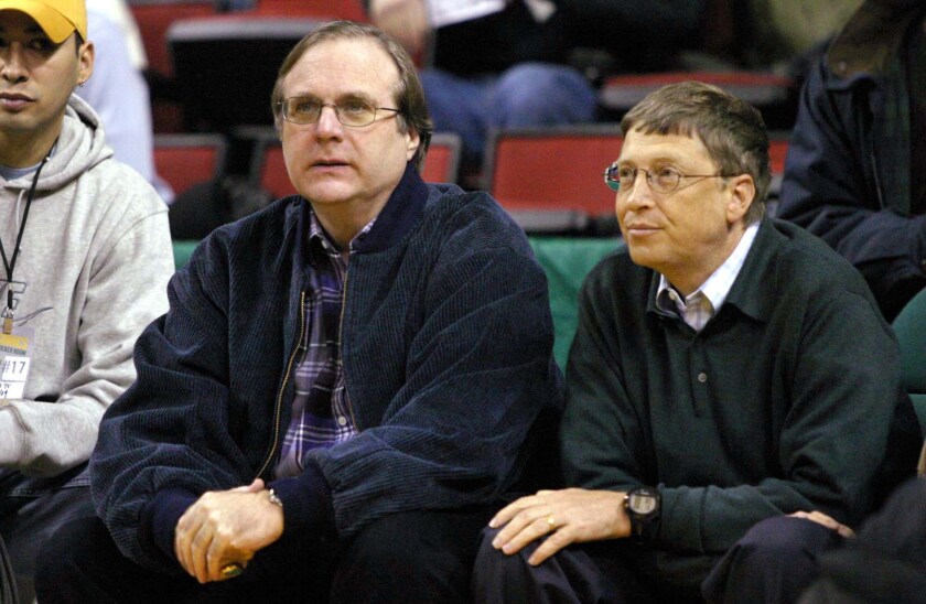 Paul Allen, owner of the Portland Trail Blazers and co-founder of Microsoft Corp., left, sits with Bill Gates, chairman and co-founder of Microsoft Corp., during a Blazers basketball game at the Key Arena in Seattle in 2004.