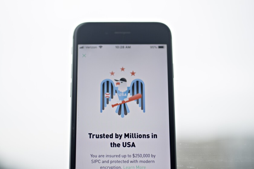 The Robinhood application is displayed on an Apple Inc. iPhone in an arranged photograph taken in Washington, D.C., U.S., on Friday, Dec. 14, 2018. The Securities Investor Protection Corp. said a new checking account from Robinhood Financial LLC raises red flags and that the deposited funds may not be eligible for protection. Photographer: Andrew Harrer/Bloomberg