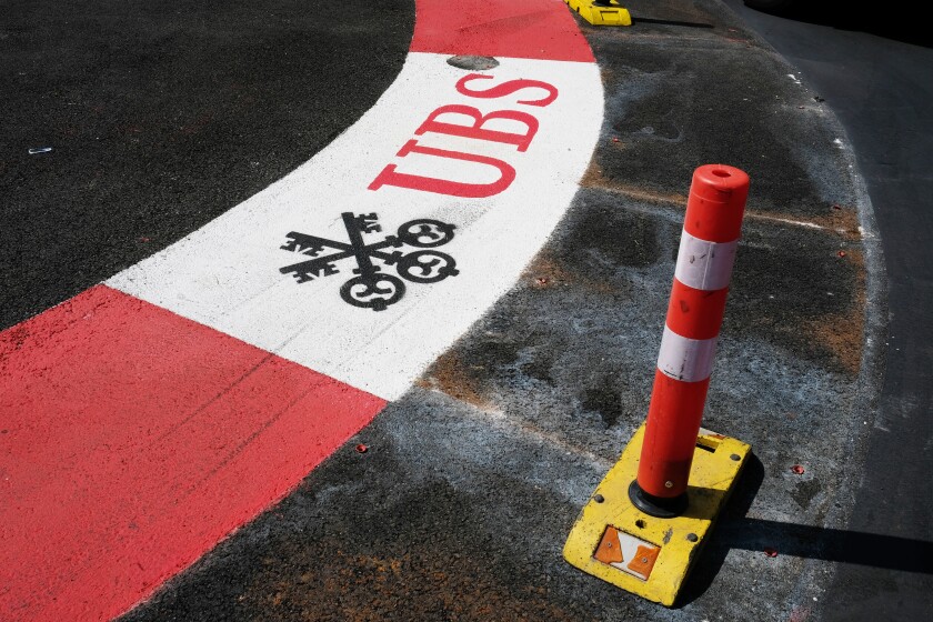 Branding for the Swiss bank, UBS Group AG, a sponsor of the Monaco Grand Prix is seen painted onto the road surface of the Formula One Grand Prix Circuit in Monte Carlo, Monaco, on Tuesday, May 29, 2018. The Monaco Grand Prix is the premier race on the Formula 1 calendar and has been held in one form or another since 1929 and in modern form since 1950. Photographer: Bryn Colton/Bloomberg
