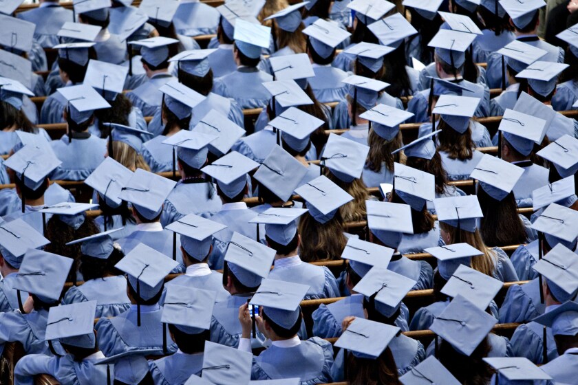 Graduates listen as Vikram Pandit, chief executive officer of Citigroup Inc., speaks during the Columbia University School of International and Public Affairs commencement at Riverside Church in New York.