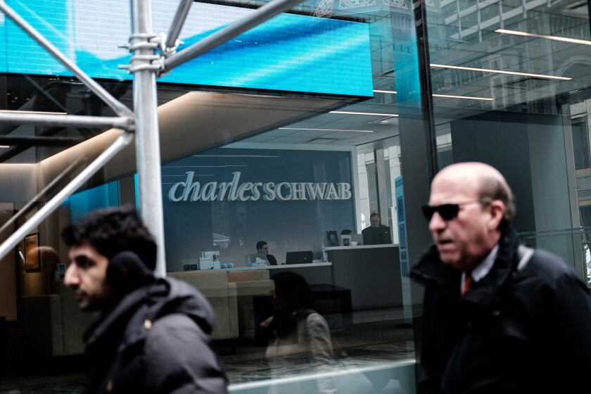 A person enters a Charles Schwab Corp. office building in New York, U.S., on Thursday, Jan. 10, 2019. Charles Schwab Corp. is scheduled to release earnings on January 16. Photographer: Gabriella Angotti-Jones/Bloomberg
