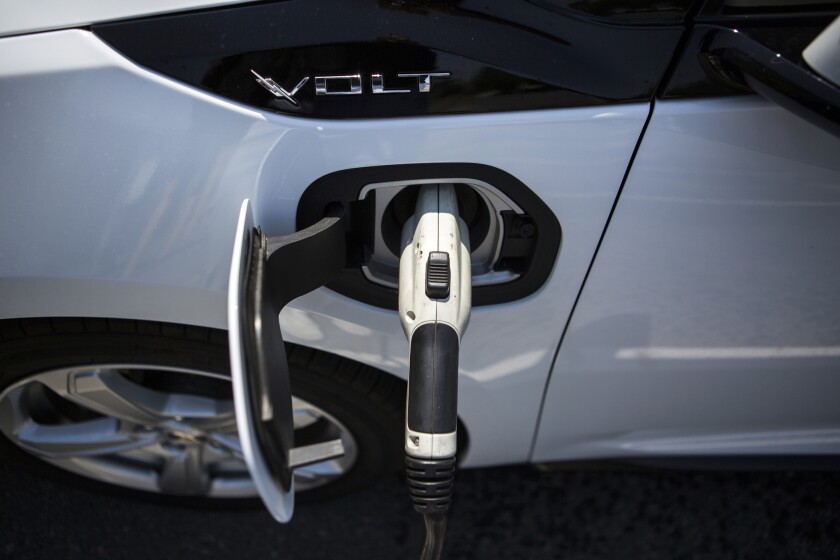 A ClipperCreek Inc. charging plug connected to a General Motors Chevrolet Volt electric vehicle at a charging station in Los Angeles