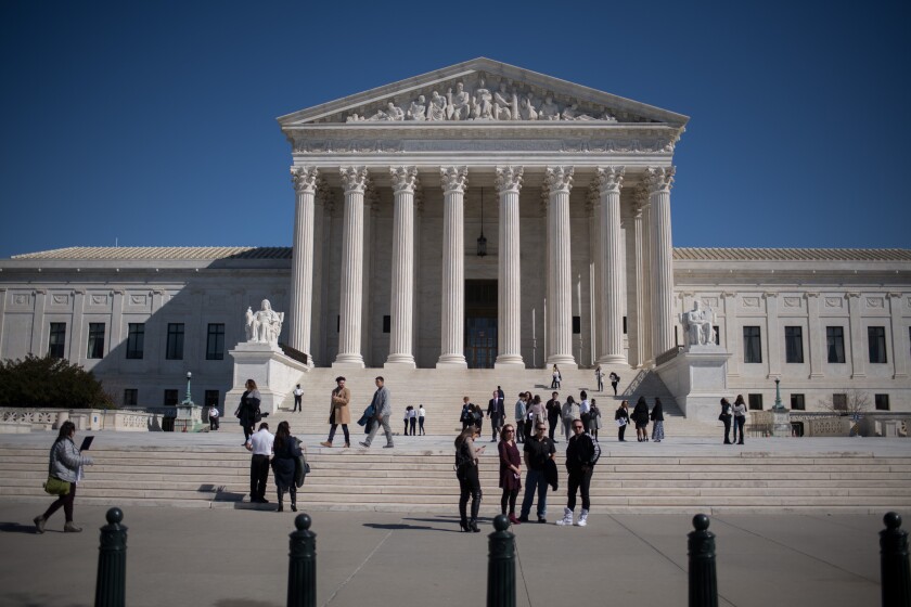 Visitors stand outside the U.S. Supreme Court in Washington, D.C., U.S., on Tuesday, Feb. 27, 2018.