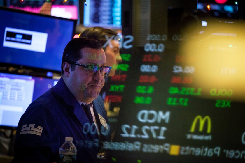 A trader works on the floor of the New York Stock Exchange (NYSE) in New York, U.S., on Tuesday, Jan. 2, 2018