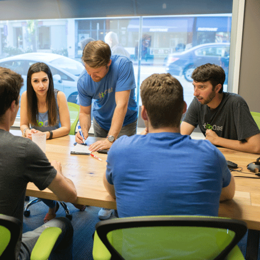 FloQast employees meet in the boardroom