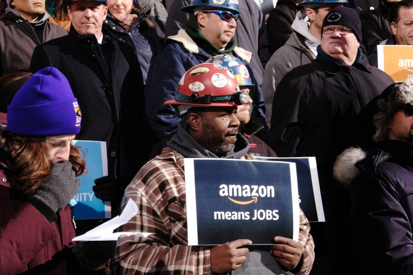 A pro-Amazon protester outside City Hall.