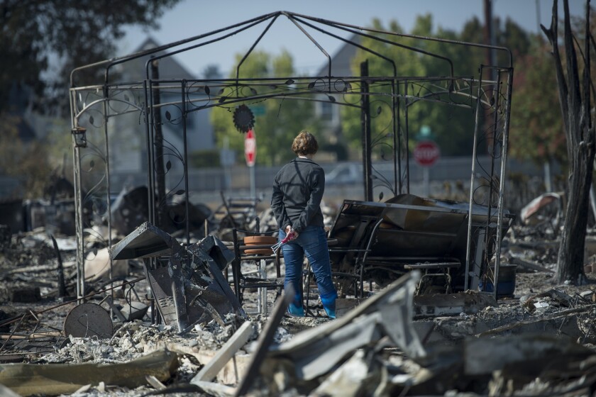 Resident views personal items burned by wildfires in Santa Rosa, California, U.S., on Thursday, Oct. 12, 2017.