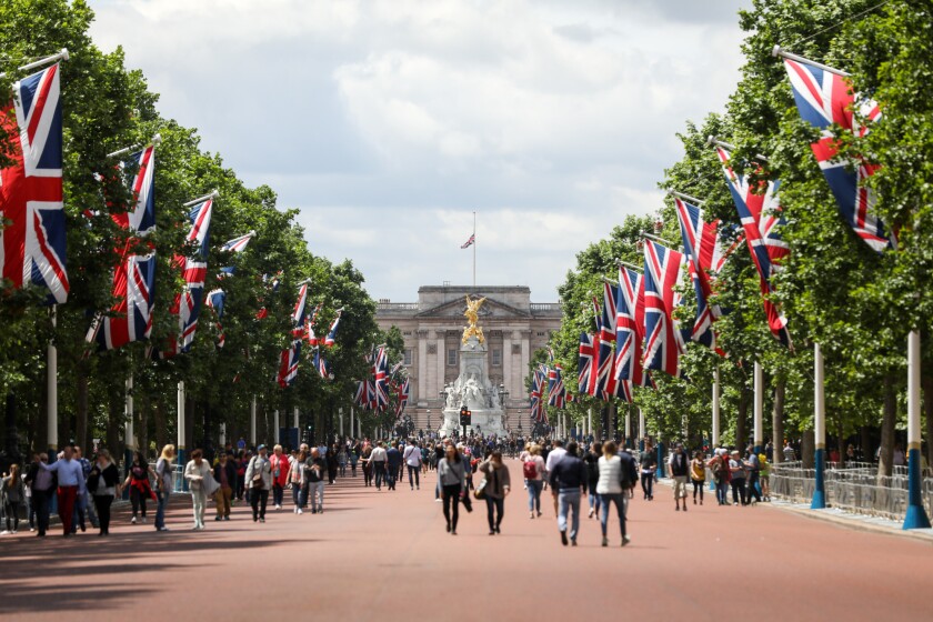 Buckingham palace with English flags