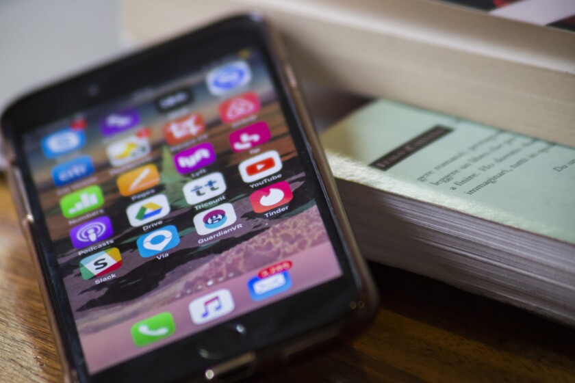 Applications icons are displayed on an Apple iPhone