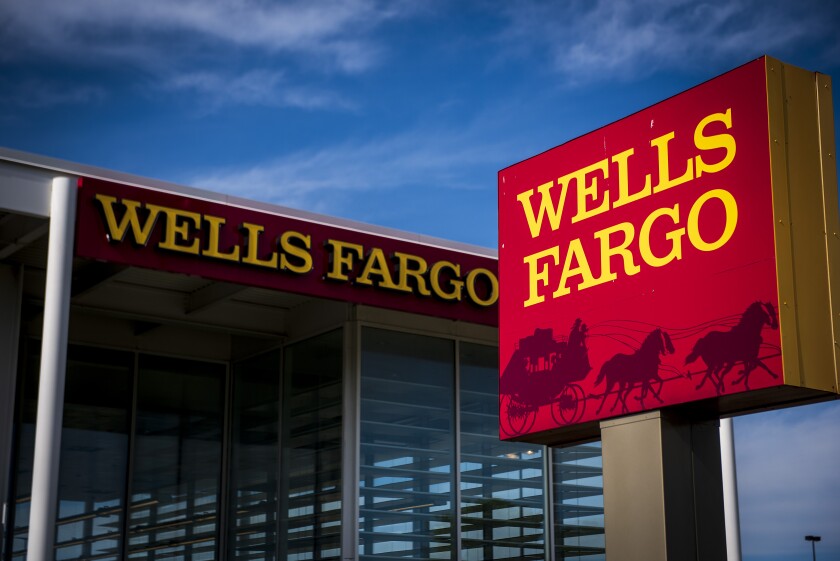 Signage is displayed outside a Wells Fargo & Co. bank branch in Niles, Illinois, U.S., on Tuesday, July 10, 2018. Wells Fargo & Co. is scheduled to release earnings figures on July 13. Photographer: Christopher Dilts/Bloomberg