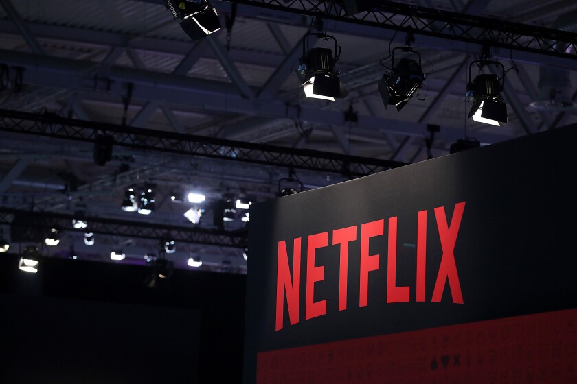 A Netflix Inc. logo sits on the online television streaming company's exhibition area at the Gamescom gaming industry event in Cologne, Germany, on Tuesday, Aug. 20, 2019. Photographer: Krisztian Bocsi/Bloomberg