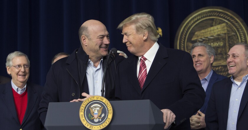 President Donald Trump, center right, and Gary Cohn, director of the U.S. National Economic Council, center left, smile during a press conference with cabinet members and Republican leadership at Camp David.