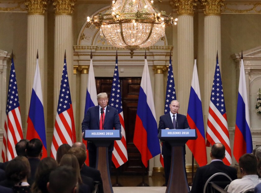 U.S. President Donald Trump, left, listens as Vladimir Putin, Russia's President, speaks during a news conference in Helsinki, Finland.