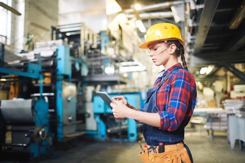 Manufacturing female engineer with mobile device.jpeg