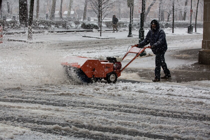 A resident uses a snowblower to clear a sidewalk during Winter Storm Quinn in Philadelphia, Pennsylvania, U.S., on Wednesday, March 7, 2018.