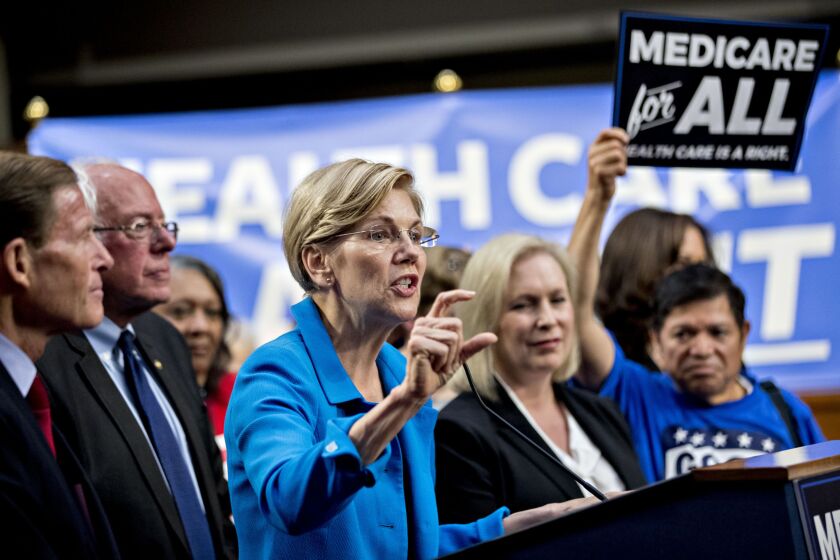 Senator Elizabeth Warren, a Democrat from Massachusetts, center, speaks during a health care bill news conference on Capitol Hill in Washington, D.C., alongside Senators Richard Blumenthal, D-Conn., Bernie Sanders, I-Vt., and Kirsten Gillibrand, D-N.Y.