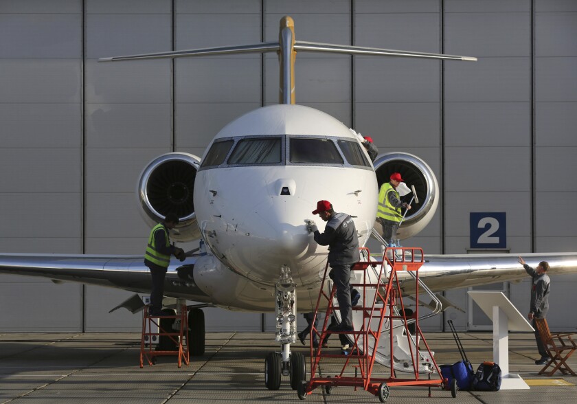 Workers prepare a Bombardier Global 6000 aircraft ahead of the Jet Expo 2012 exhibition at Vnukovo airport in Moscow.