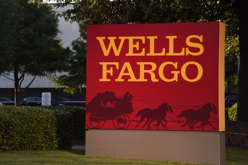 Wells Fargo signage displayed outside a bank branch in Dallas on Monday, July 10, 2017 Bloomberg News