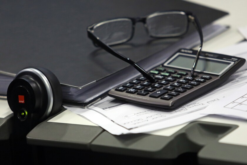 Calculator, glasses by Bloomberg News