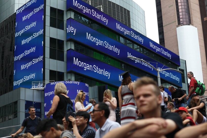 People sit across from Morgan Stanley headquarters in New York, U.S., on Thursday, July 12, 2018. Morgan Stanley is scheduled to release earnings figures on July 18. Photographer: Bess Adler/Bloomberg