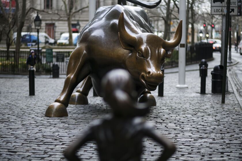 A statue of a defiant girl stands facing the Charging Bull sculpture in the Financial District of New York, U.S., on Wednesday, March 8, 2017. State Street Global Advisors, a nearly $2.5 trillion investor and unit within State Street Corp., installed the bronze statue in front of Wall Street's iconic charging bull as part of its new campaign to pressure companies to add more women to their boards. Photographer: Jeenah Moon/Bloomberg