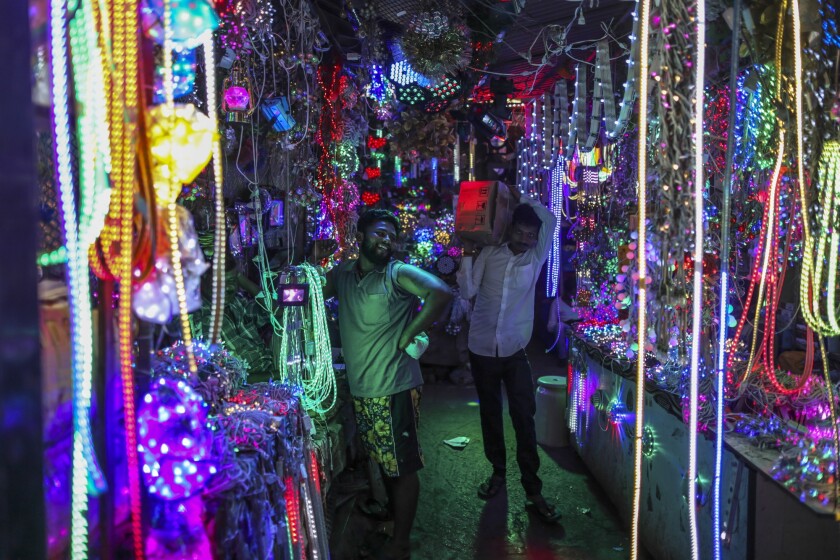 A customer browses a light system at a wholesale shop near a market in Mumbai, India.