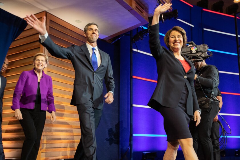 2020 Democratic presidential candidates Senator Amy Klobuchar, a Democrat from Minnesota, from right, Beto O'Rourke, former Representative from Texas, Senator Elizabeth Warren, a Democrat from Massachusetts, and Senator Cory Booker, a Democrat from New Jersey, arrive on stage during the Democratic presidential candidate debate in Miami, Florida, U.S., on Wednesday, June 26, 2019. Democratic presidential candidates tangled on health care in their first debate Wednesday, agreeing on the need for universal coverage but disagreeing about whether private insurance should be maintained. Photographer: Jayme Gershen/Bloomberg