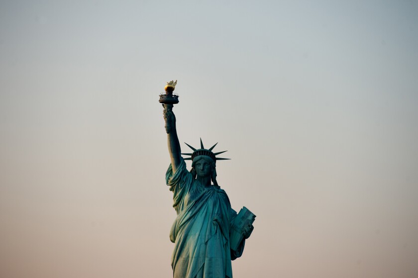 The Statue of Liberty stands in this aerial photograph taken in New York, U.S. Photographer: Ron Antonelli/Bloomberg