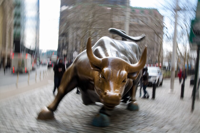 The famous bull sculpture stands near Wall Street in New York, U.S., on Friday, Feb. 12, 2016. U.S. stocks halted a five-day slide that dragged global equities into a bear market, as oil rebounded from a 12-year low and bank shares surged. Photographer: Michael Nagle/Bloomberg