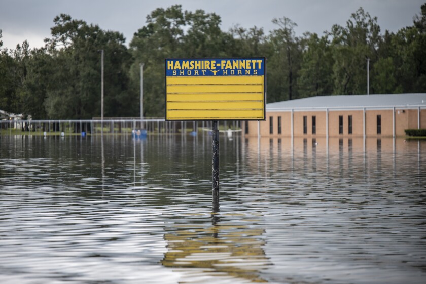 Flood water surrounds a sign for Hamsire-Fannett High School following Tropical Storm Imelda in Fannett, Texas, U.S., on Friday, Sept. 20, 2019. The remnants of Tropical Storm Imelda lashed Houston and coastal Texas, inundating homes, paralyzing travelers, disrupting oil supplies, and threatening hospitals and refineries. Photographer: Sergio Flores/Bloomberg
