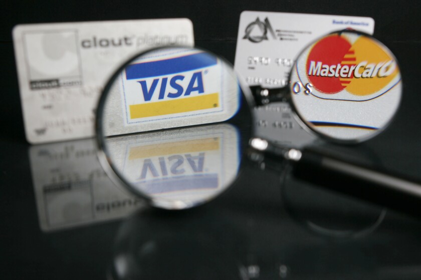 Visa, Mastercard cards under the magnifying glass
