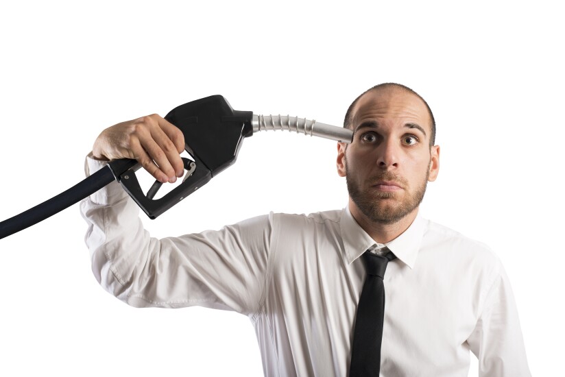 Man holding gasoline pump to his head