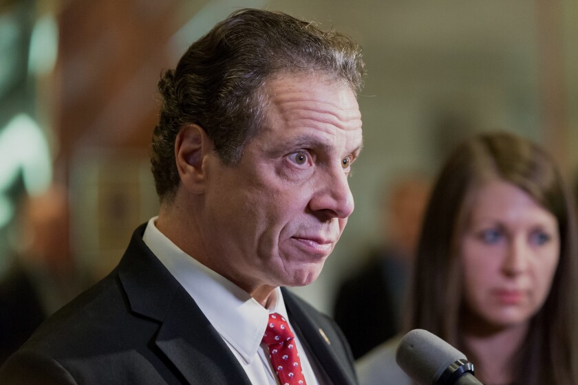 Andrew Cuomo, governor of New York, speaks with members of the media in the lobby of Trump Tower in New York, U.S., on Wednesday, Jan. 18, 2017.