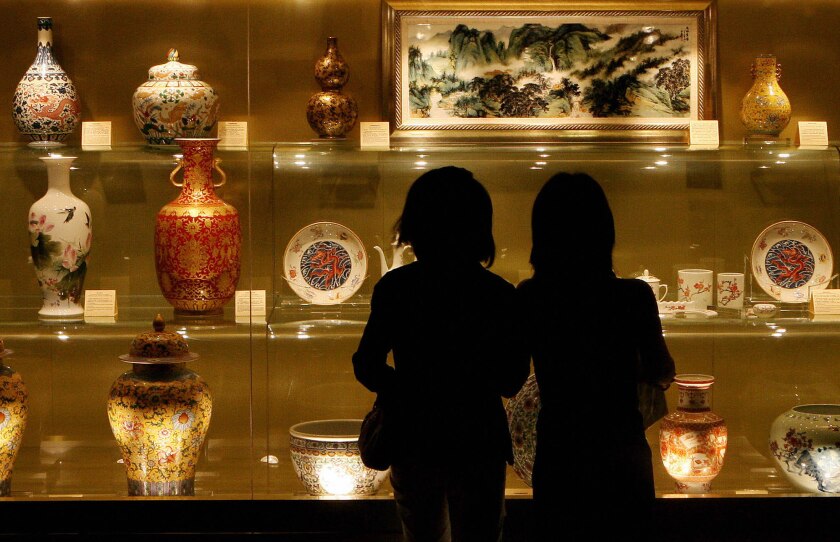 Visitors view a display of Chinese antiques at a preview day for the Millionaire Fair in Shanghai.