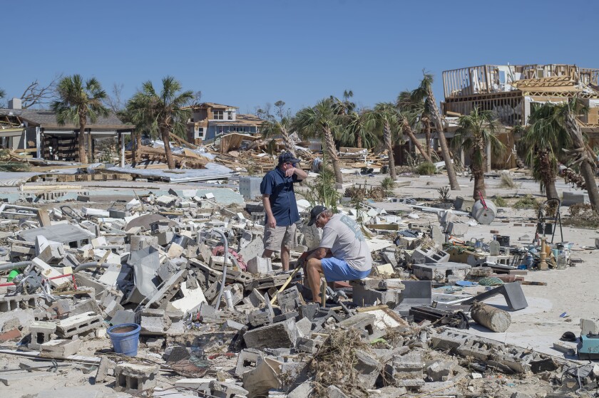 Residents survey debris after Hurricane Michael hit in Mexico Beach, Florida, U.S., on Friday, Oct. 12, 2018.