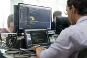 Asian Outsource Developer Looking Screen Sitting At Desk Working