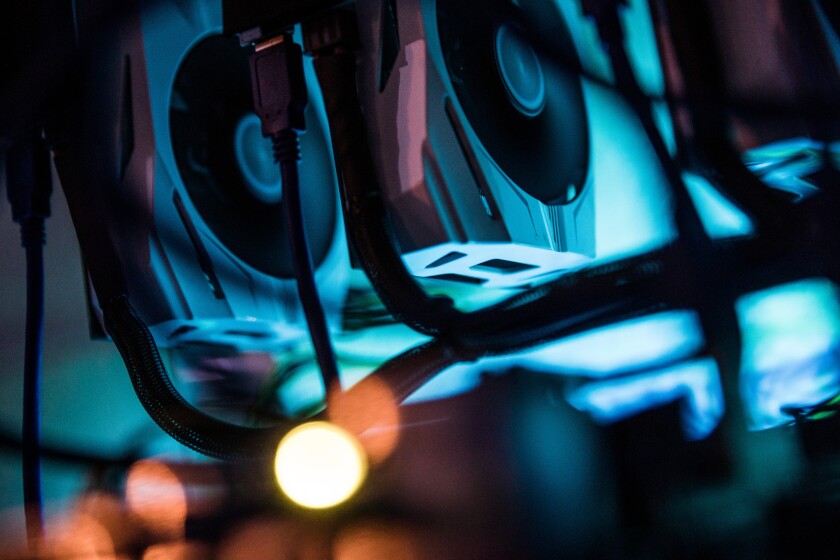 Nvidia GeForce GTX 1070 graphic processing units stacked inside a mining rig computer, used to mine the Ethereum cryptocurrency.