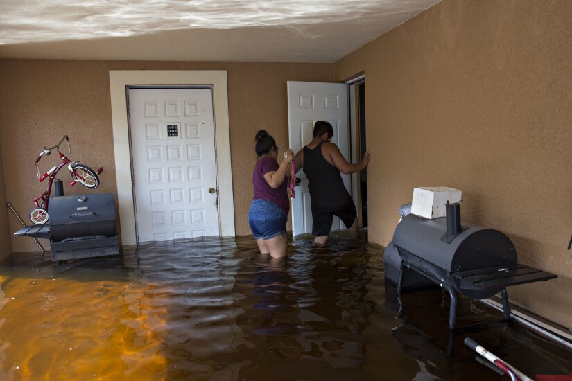 Residents enter their flooded home to collect personal belongings in Bonita Springs, Florida, after Hurricane Irma.